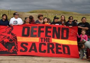 Native Americans march to a burial ground sacred site that was disturbed by bulldozers building the Dakota Access Pipeline (DAPL), near the encampment where hundreds of people have gathered to join the Standing Rock Sioux Tribe's protest of the oil pipeline that is slated to cross the Missouri River nearby, September 4, 2016 near Cannon Ball, North Dakota. Protestors were attacked by dogs and sprayed with an eye and respiratory irritant yesterday when they arrived at the site to protest after learning of the bulldozing work. / AFP / Robyn BECK        (Photo credit should read ROBYN BECK/AFP/Getty Images)